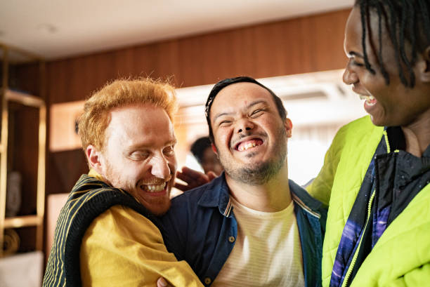 istock Disabled young man having fun with his friends at home 1414287435