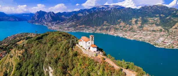 Photo of Italian lakes scenery. Amazing Iseo lake aerial view.  one of the most beautiful places - Shrine of Madonna della Ceriola in Monte Isola - scenic island in the moddle of lake. Italy travel destinations and landmarks