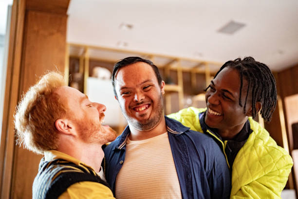 istock Disabled young man and his friends embraced at home 1414287454