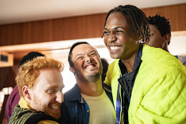 istock Disabled young man having fun with his friends at home 1414287469
