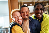 istock Portrait of a disabled young man and his friends embraced at home 1414287472