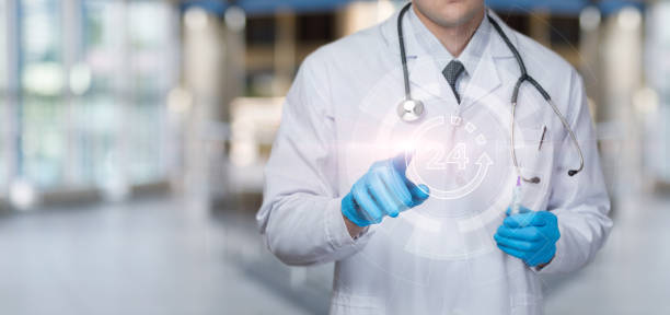 istock Doctor clicks on virtual screen for 24 hour service. 1414287611