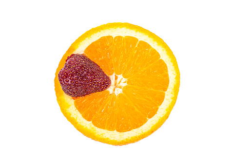 Ripe strawberry berry on a piece of juicy orange, isolated on a white background, close-up