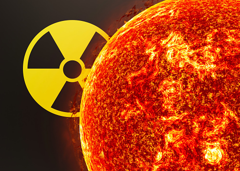 Nuclear energy radioactive round yellow symbol and nuclear explosion on black background. Ionizing atomic radiation. Radioactive alert, warning, danger. Radioactivity, nuclear threat. 3d rendering