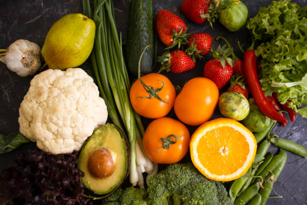 istock Different vegetables and fruits on a dark background 1414293073