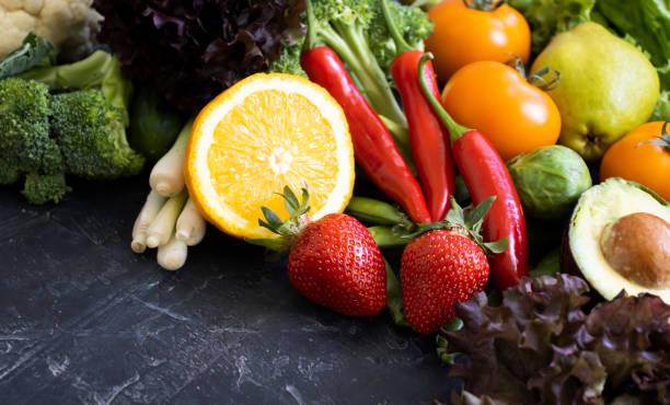 istock Different vegetables and fruits on a dark background 1414293837