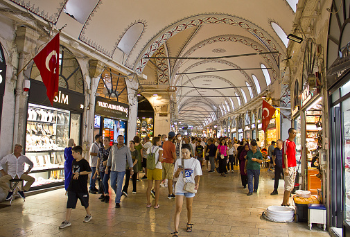Istanbul,Turkey - August 10, 2022: People walk and shop in grand bazaar (kapalı çarşı), famous for jewelery, spice, leather and Turkish carpet shopping.
