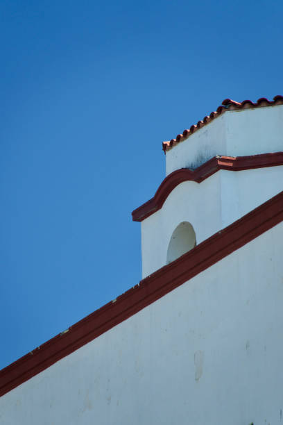 istock Spanish building with red trim against a bright blue sky 1414294672