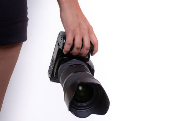 latina woman's hand holding camera isolated on white background, photography course concept