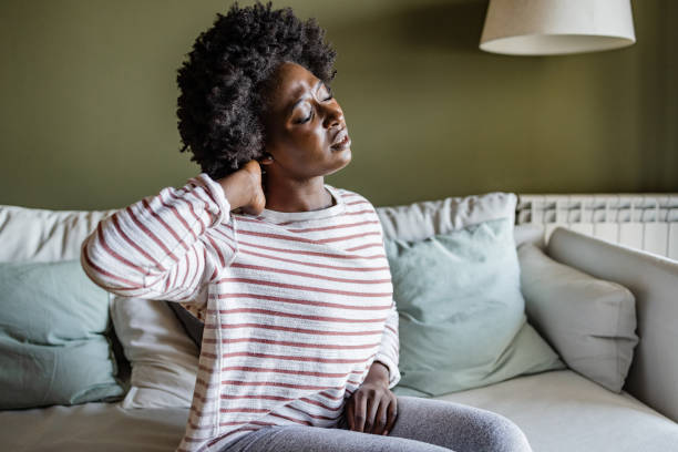 istock Young woman having neck pains 1414297716