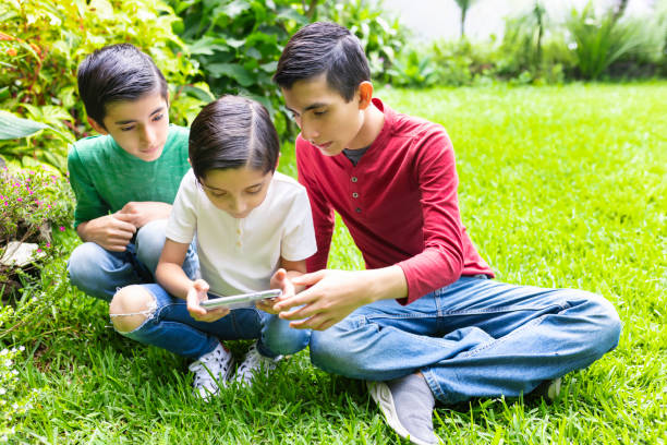 istock Children in the grass 1414300509