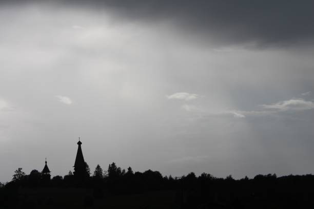 in the village, the outline of the cathedral and the bell tower was photographed on a cloudy summer day