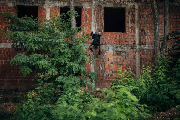 Swat police officer falling of an abandon building.