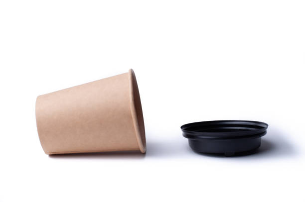 istock disposable cardboard coffee cup isolated on white background, drop on surface 1414300936