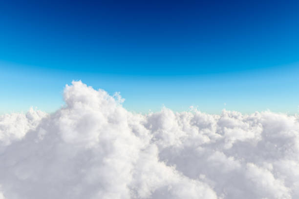 istock Above wispy clouds against a clear blue sky 1414302782
