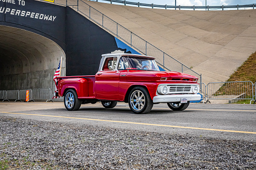 Lebanon, TN - May 14, 2022: Wide angle front corner view of a 1962 Chevrolet C10 Stepside Pickup Truck driving on a road leaving a local car show.