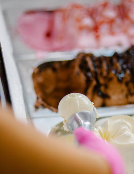 istock young man preparing ice cream with chocolate in ice cream parlor 1414306668