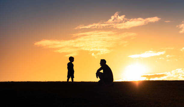 istock Father son having a talk together outdoors. 1414308104