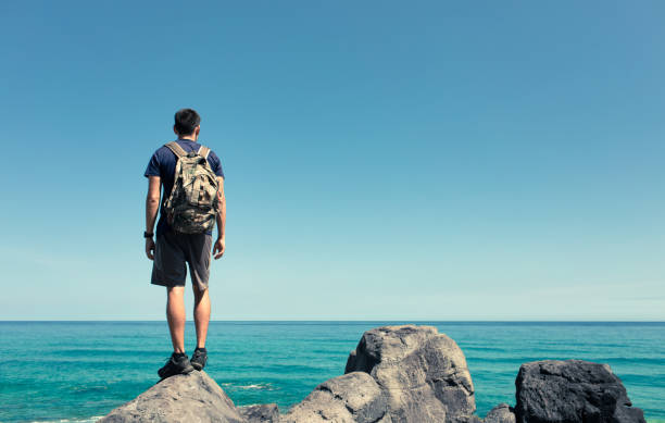 istock Man hiker enjoying beautiful view from mountain top. 1414308145