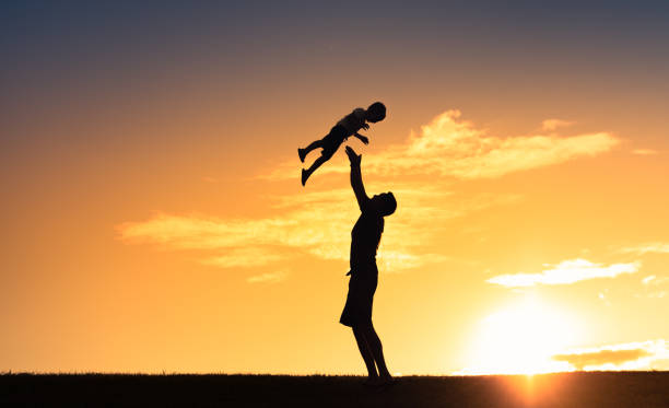 istock Happy father and son playing together at sunset. 1414308149