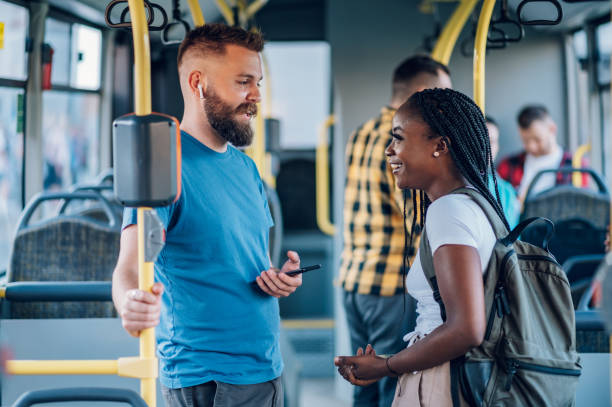 istock Multiracial friends talking while riding a bus in the city 1414309231