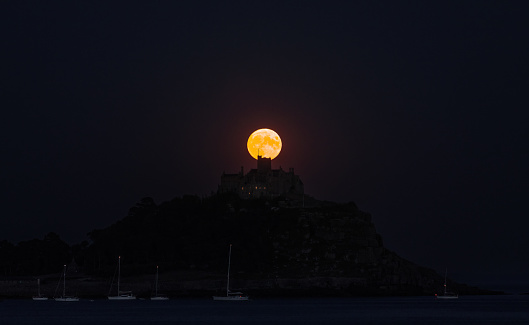 St. Michaels Mount, Marazion, UK\n\nThe Sturgeon Moon rounds out this year’s parade of four supermoons, which started in May! Supermoons are commonly defined as full Moons that occur while the Moon is at its nearest point to Earth. (Because its orbit is not a perfect circle, the Moon’s distance from Earth changes throughout the month.) Supermoons are ever-so-slightly closer to Earth than the average full Moon, which technically makes them extra large and bright from Earth’s perspective.\n\nAugust’s full Moon was traditionally called the Sturgeon Moon because the giant sturgeon of the Great Lakes and Lake Champlain were most readily caught during this part of summer.