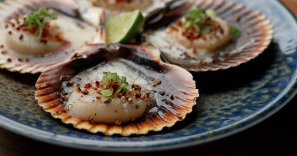 Grilled scallops with butter, quinoa pop, garlic, lime
