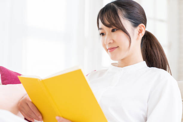 istock attractive asian woman who reads a book, 1414316402