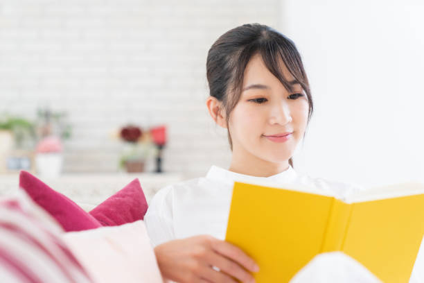 istock attractive asian woman who reads a book, 1414316471