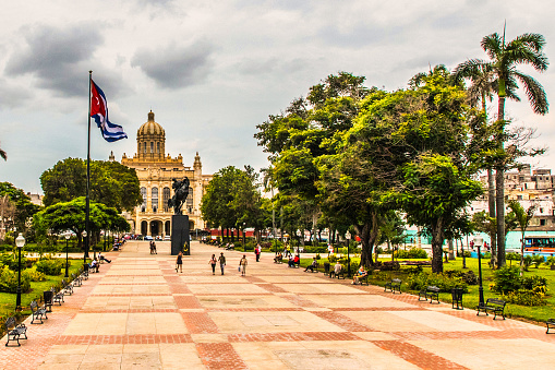 Havana, Cuba - July 06 2018 : The park in front of the museum of revolution, the park and the cuban flag.