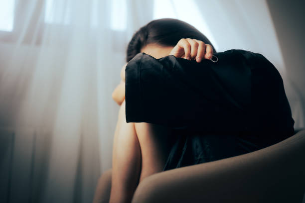 istock Sad Divorcee Holding Her Wedding Ring and Crying 1414318742