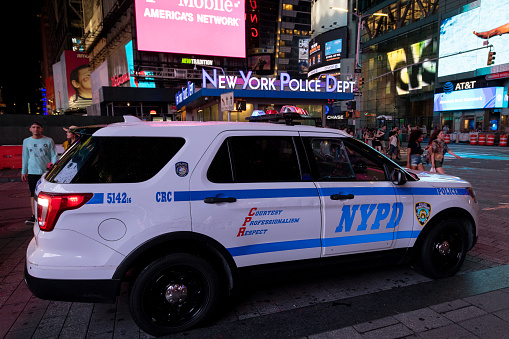 New York, USA - Jul 22, 2019: An NYPD vehicle parked in front of the NYPD Museum in Times Square early in the evening on 7th avenue in Manhattan.