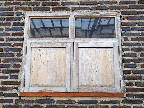 Old small window in a wooden wall