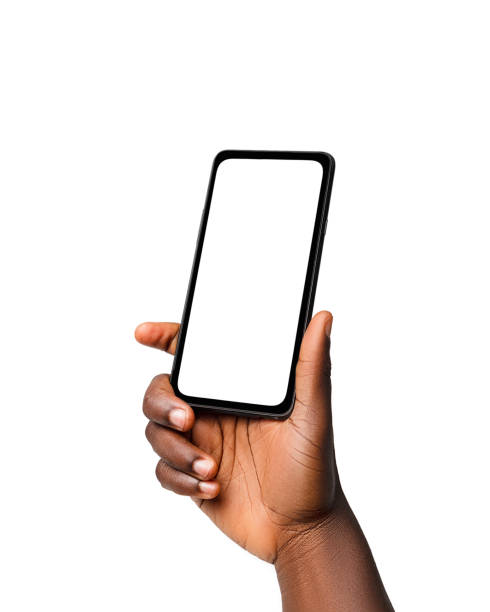 istock Black hand holding phone facing camera isolated on white background. blank screen, phone screen mockup, front view, clipping path, clipping mask 1414323947