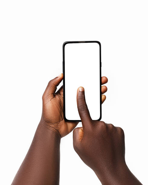 istock Black hand holding and pressing phone screen facing camera isolated on white background. blank screen, phone screen mockup, front view, clipping path, clipping mask 1414324082