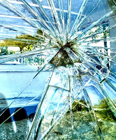 A broken windshield on a bus.