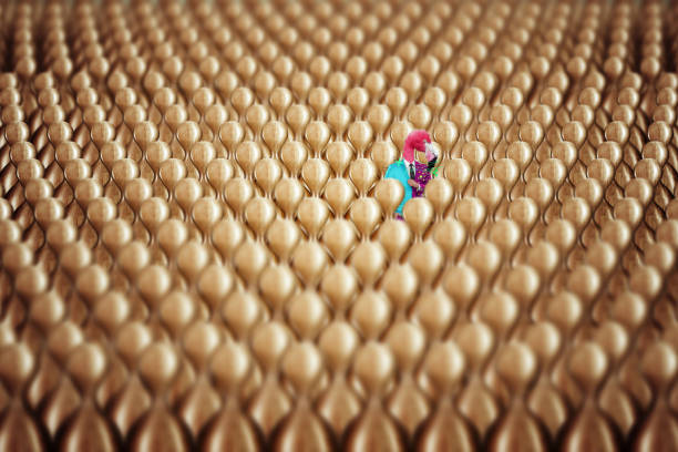 Uniqueness, there is one multi-colored character in the crowd of wooden blanks. Competitive advantage, standing out from the crowd, thinking outside the box, a leader. 3D render, 3D illustration