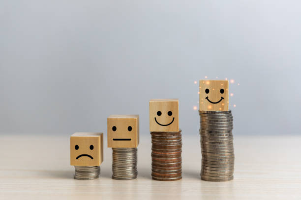 istock wood block cube emotion and coin on table.Feedback collection statistics saving finance business concept. 1414348204