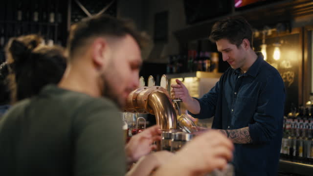 Caucasian male bartender working at bar. Shot with RED helium camera in 8K.