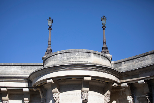 Lamp posts and some of the many mascarons which decorate the sides of Pont Neuf, Paris