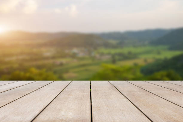 istock Empty old wooden table in front of blurred beautiful view forest, mountain and cloud over the sky on clear day. Can be used for display or montage for show your product. 1414352200