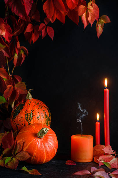 istock Halloween frame with pumpkins and burning candles on dark background. Copy space 1414352318
