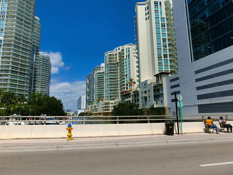 Miami, USA - April 24, 2022: Modern apartment buildings with palm trees at Avenue at Miami, Usa