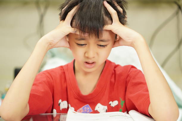 istock Image: kid becomes confused and frustrated at solving math problems. Portrait, close-up. 1414354296