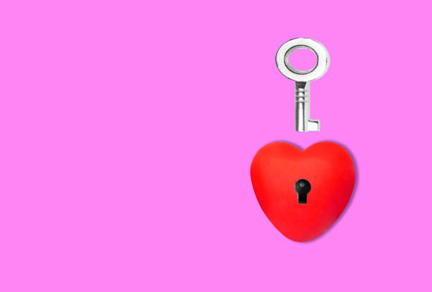 istock Key and heart shape with keyhole on pink 1414354309