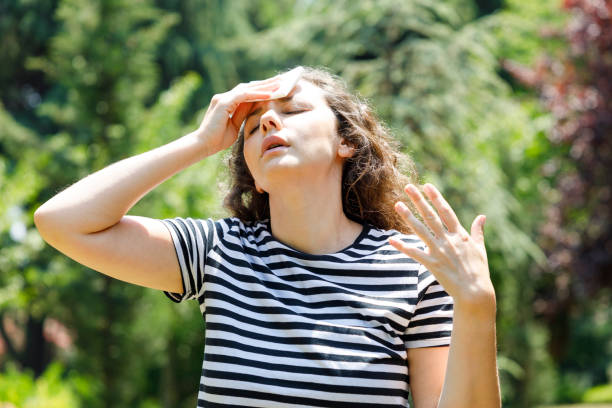 istock Young woman having hot flash and sweating in a warm summer day 1414360398