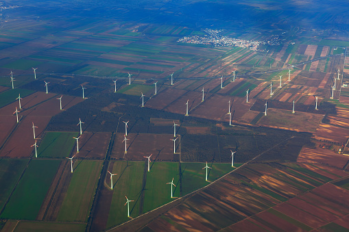 Onshore wind farm view from above . Wind generators on the meadow