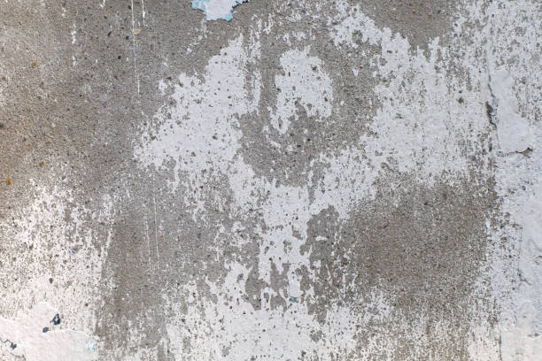 istock Worn concrete wall texture background with paint partly faded 1414362212