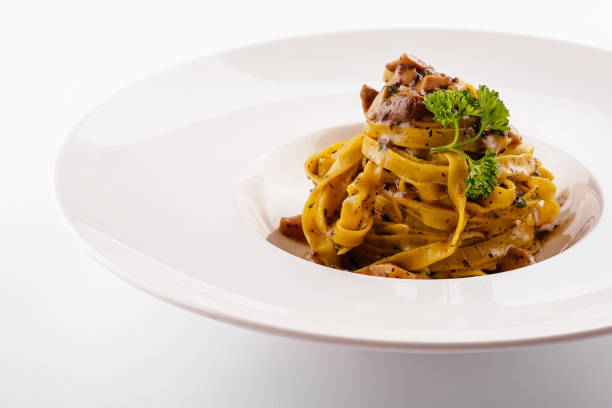 istock Pasta with mushrooms on white plate 1414370278