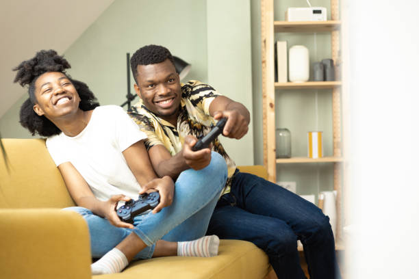 istock Happy African couple gaming and having fun 1414373934